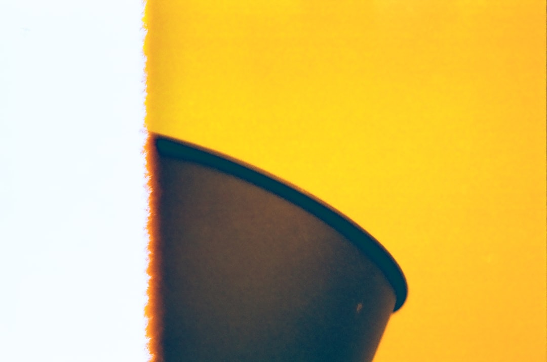 Abstract yellow and white shapes with dark curved shadow.