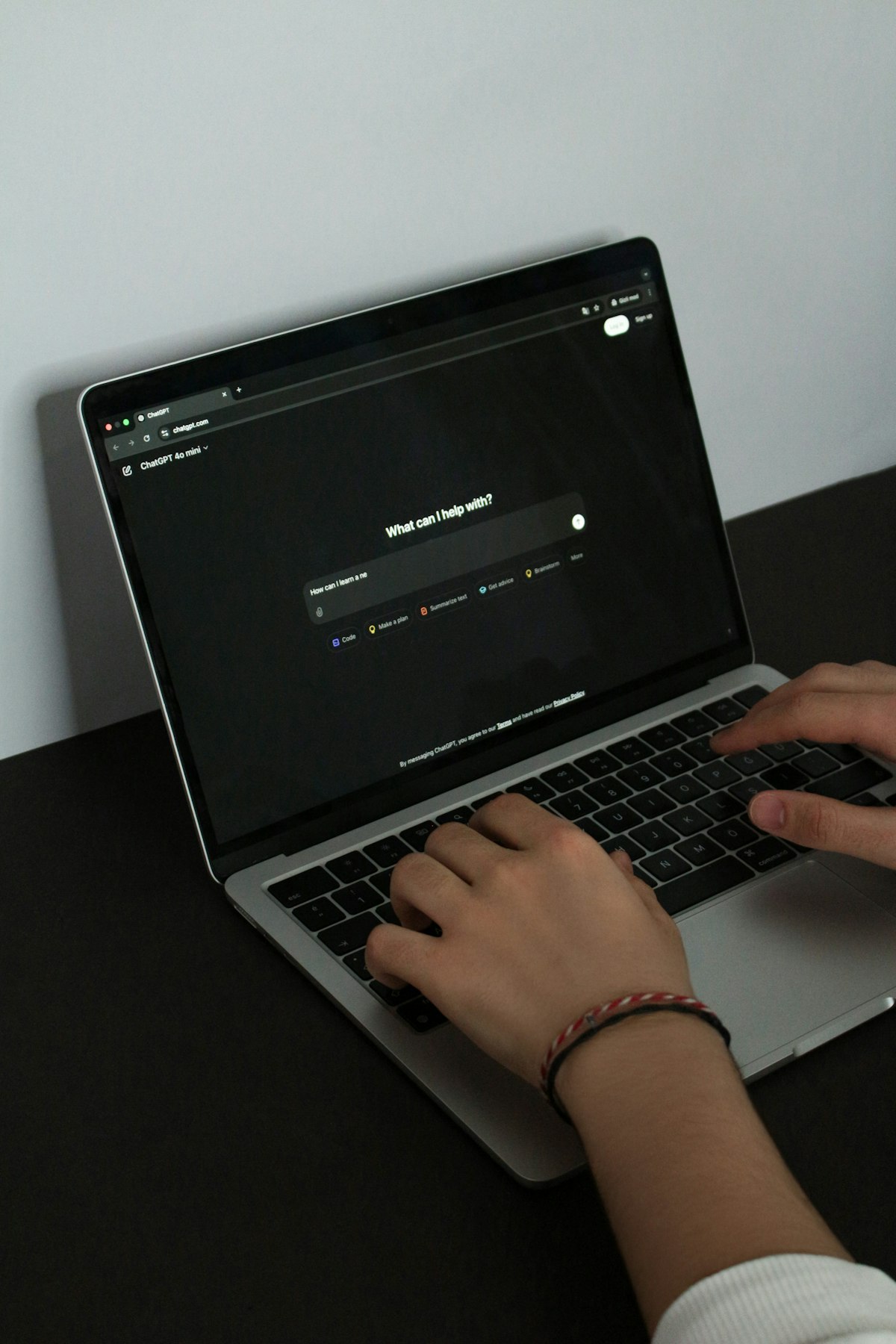 GPT-5.5 Instant freelancer working on laptop with ChatGPT open