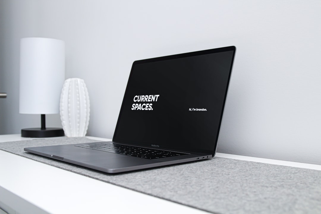 Laptop on a minimal desk representing Canva AI tools for productivity