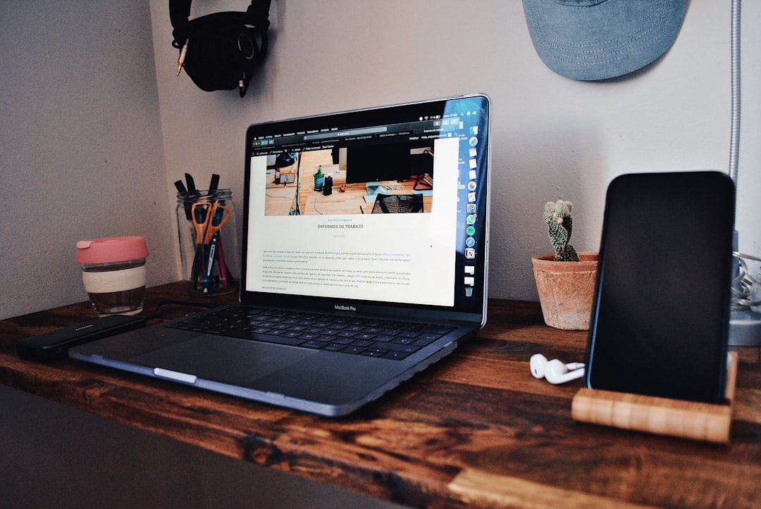Laptop on a wooden desk representing a ChatGPT vs Claude email workflow