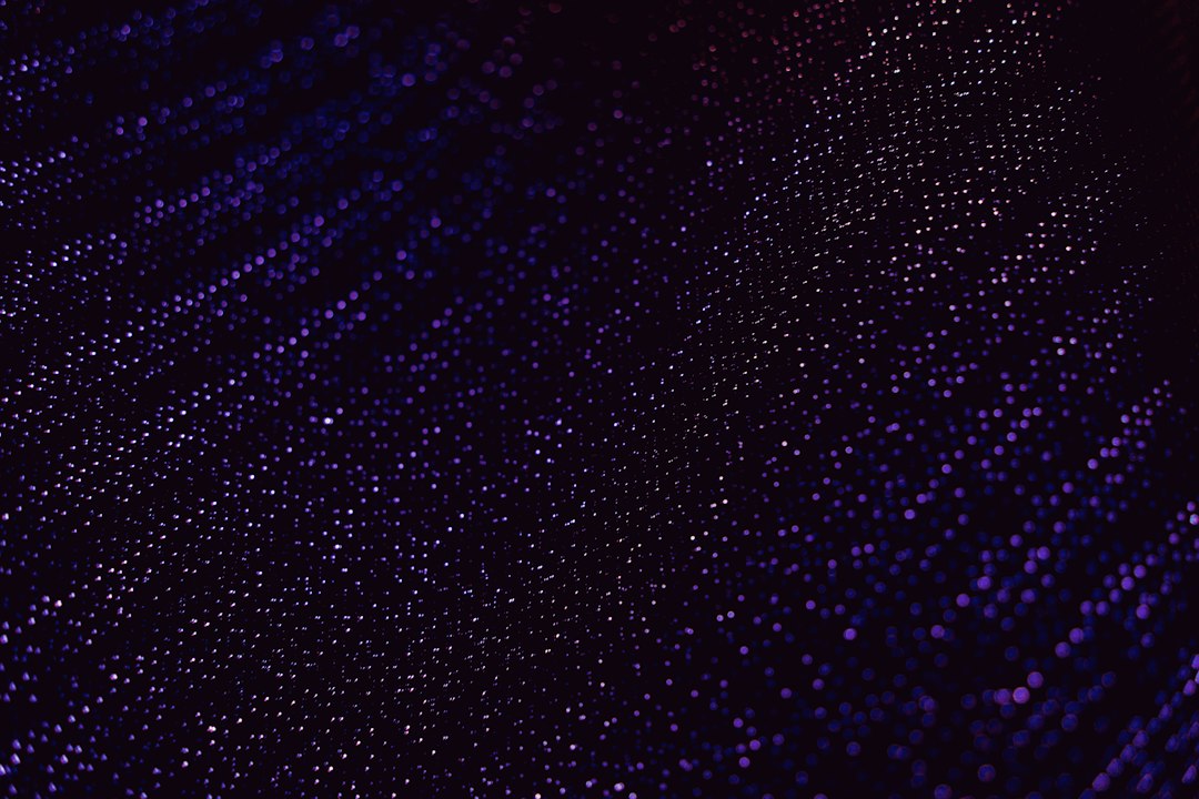 Abstract pattern of small glowing lights representing OpenAI dots always-on agents for productivity and ops